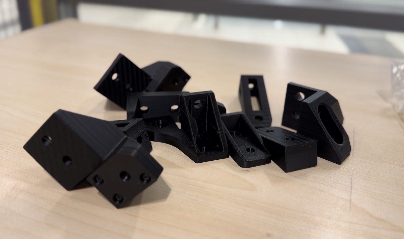 Printed brackets and connectors laid out on a table